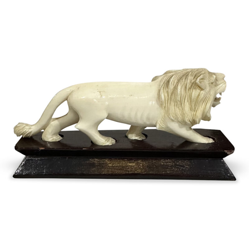 Oriental ivory lion on timber platform base c. 1930