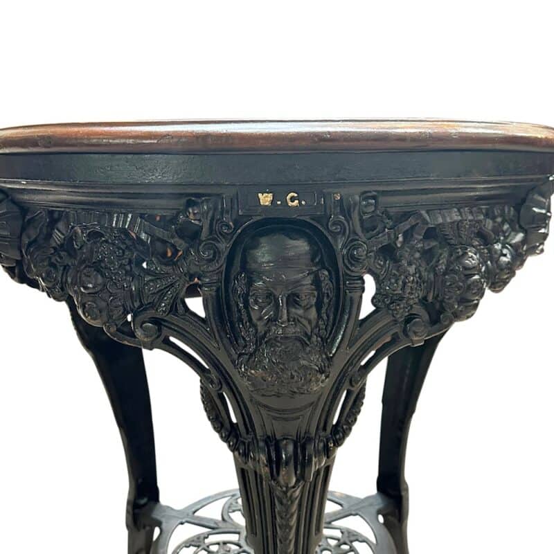 Antique cast iron pub table featuring cricketer WG Grace