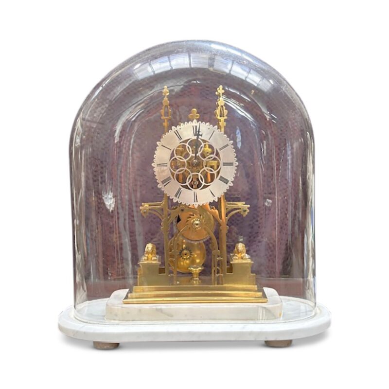 19th century brass skeleton clock in glass dome on marble base